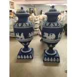 A pair of jasper ware Adams vases decorated with classical scenes and seven other vases .
