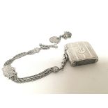A silver Vesta case with attached chain and silver