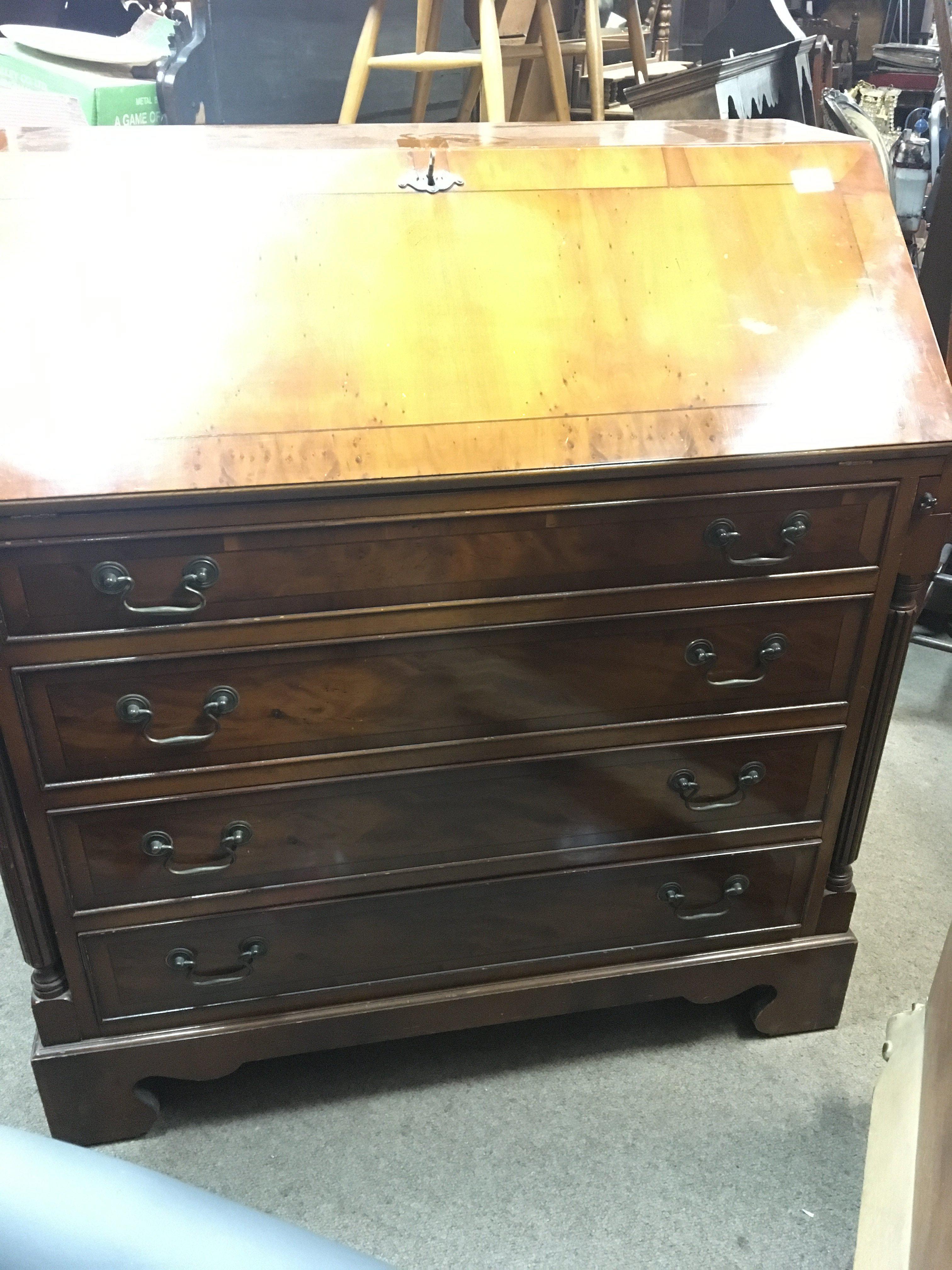 A Yew wood bureau with a well fitted interior abov