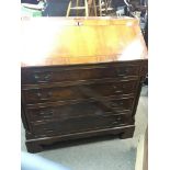 A Yew wood bureau with a well fitted interior abov