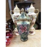 Three Victorian ceramic urns and covers comprising