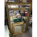 Three gilt framed wall mirrors, largest measuring
