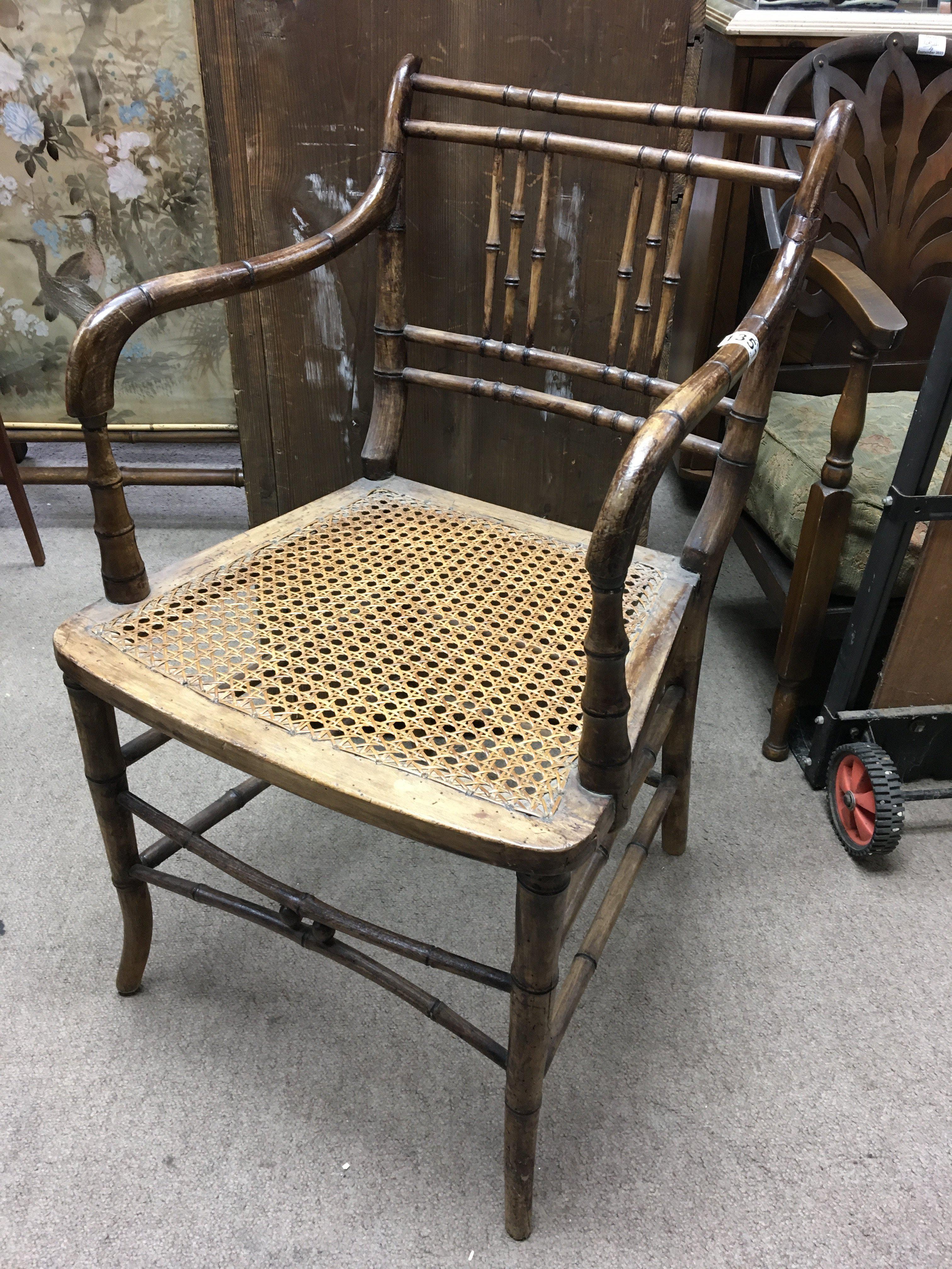 A Regency cane open armchair with cane seat United