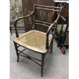 A Regency cane open armchair with cane seat United