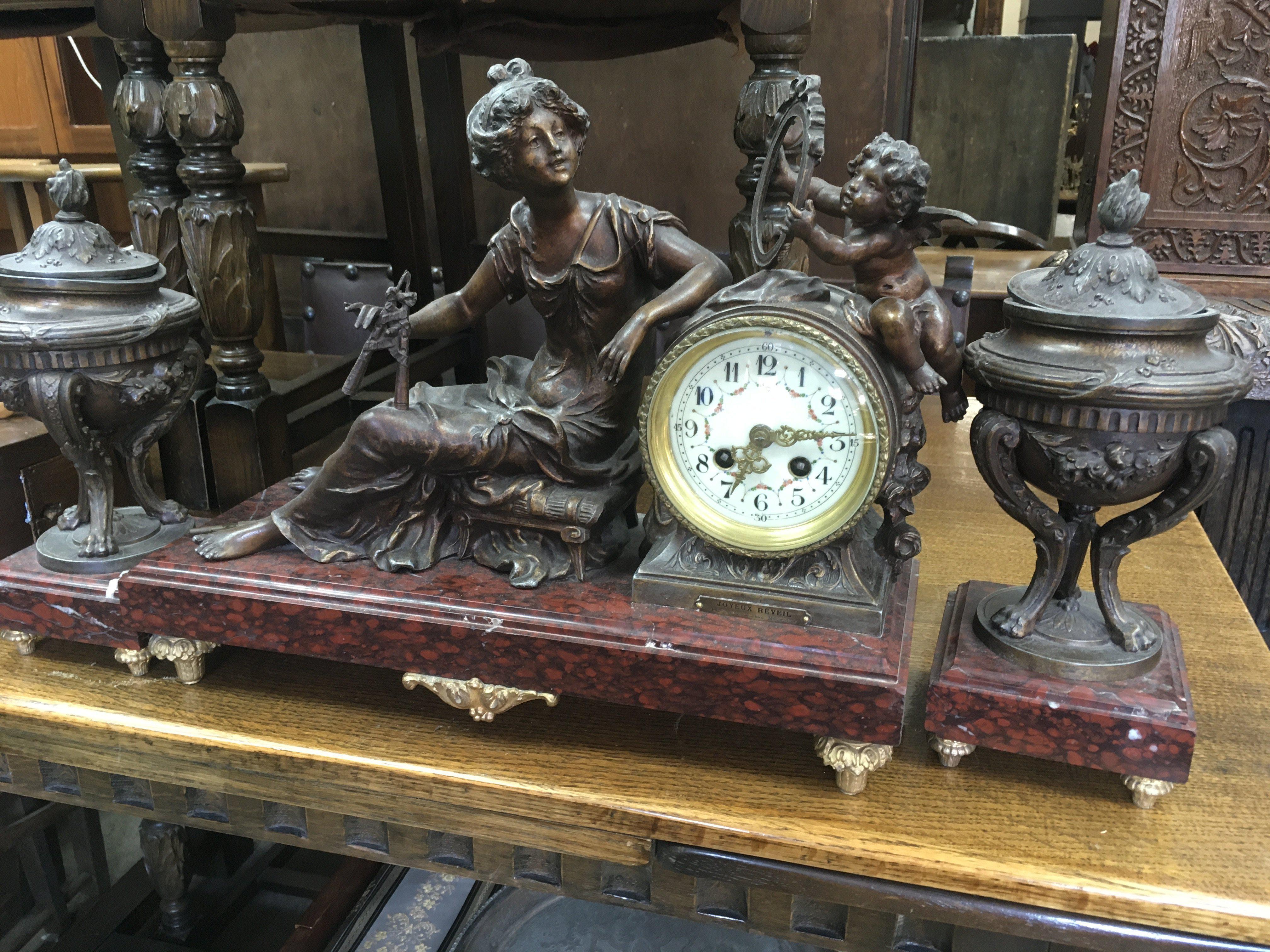 A spelter clock of classical form in the form of m