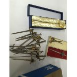 A collection of miniature presentation swords.