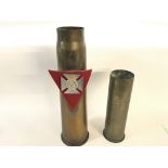 A pair of large brass shell cases.