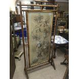 A bamboo screen decorated with birds, flowers and