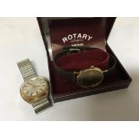 A gold Rotary watch in a box with paperwork, and a