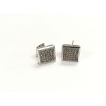 A pair of 10k white gold pave set diamond earrings