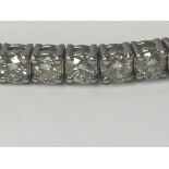 A diamond 18 ct white gold line bracelet inset wit