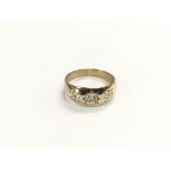 A 9ct gold three stone diamond gypsy ring, approx