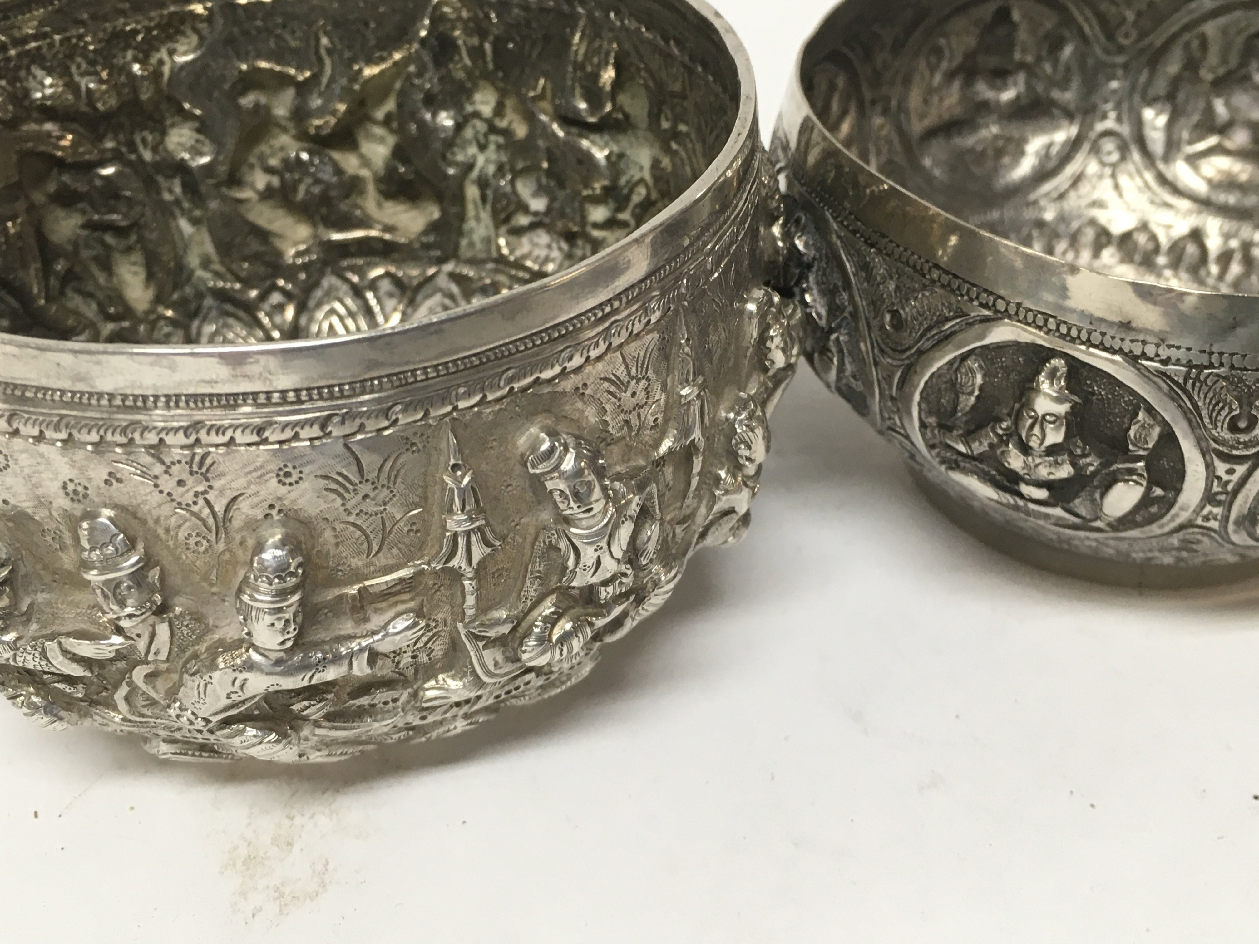 Two Indian white metal bowls with raised deity .