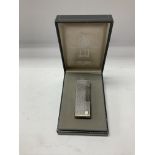 A vintage cased Dunhill lighter with original oute