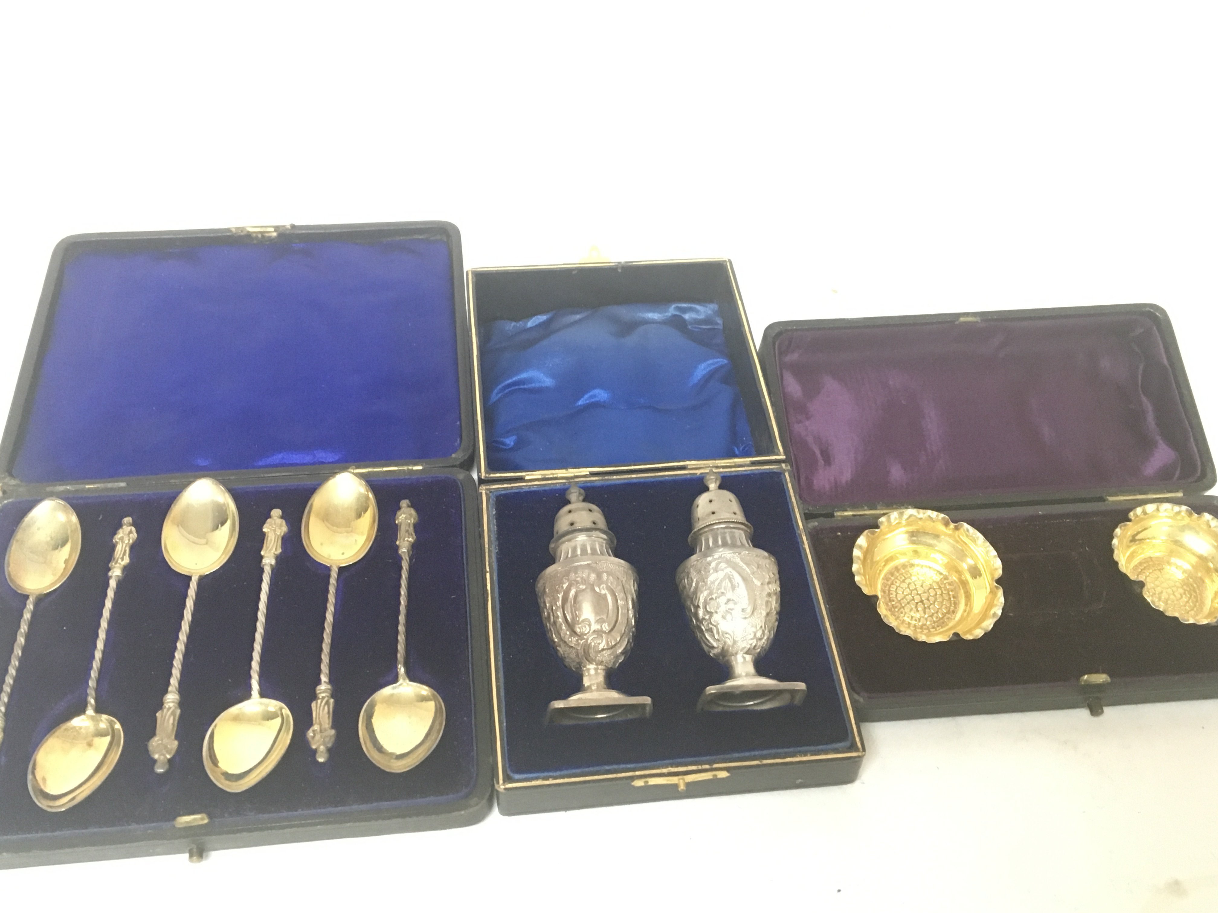 A cased pair of silver condiments, silver gilt sal
