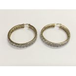 A pair of 9ct gold stone set hoop earrings, approx