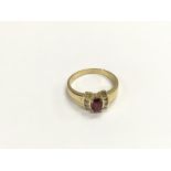 An 18ct gold ring set with a central oval cut ruby