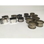 A collection of silver napkin rings including engi