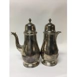 A pair of silver Coffee/ hot chocolate pots 676 grams Sheffield hallmarks Mappin and Webb.