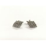 A pair of 18ct white gold pave set diamond cluster