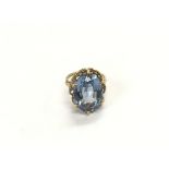 A 9ct gold ring set with an oval pale blue stone,