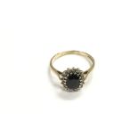 A 9ct gold, oval sapphire and diamond cluster ring