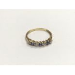 A 14ct gold QVC ring set with pale blue sapphires,