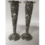 A pair of Indian silver bud vases decorated with r