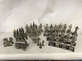 A Collection of metal figures, many mounted on woo
