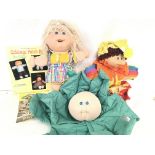 A Collection of Cabbage Patch Kids and a Encyclopa