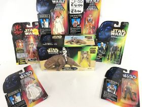 A Collection of Carded Star Wars Figures and a Box