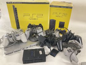A Boxed PlayStation 2.a Loose PlayStation 2 with accessories and a Large Collection of Games.