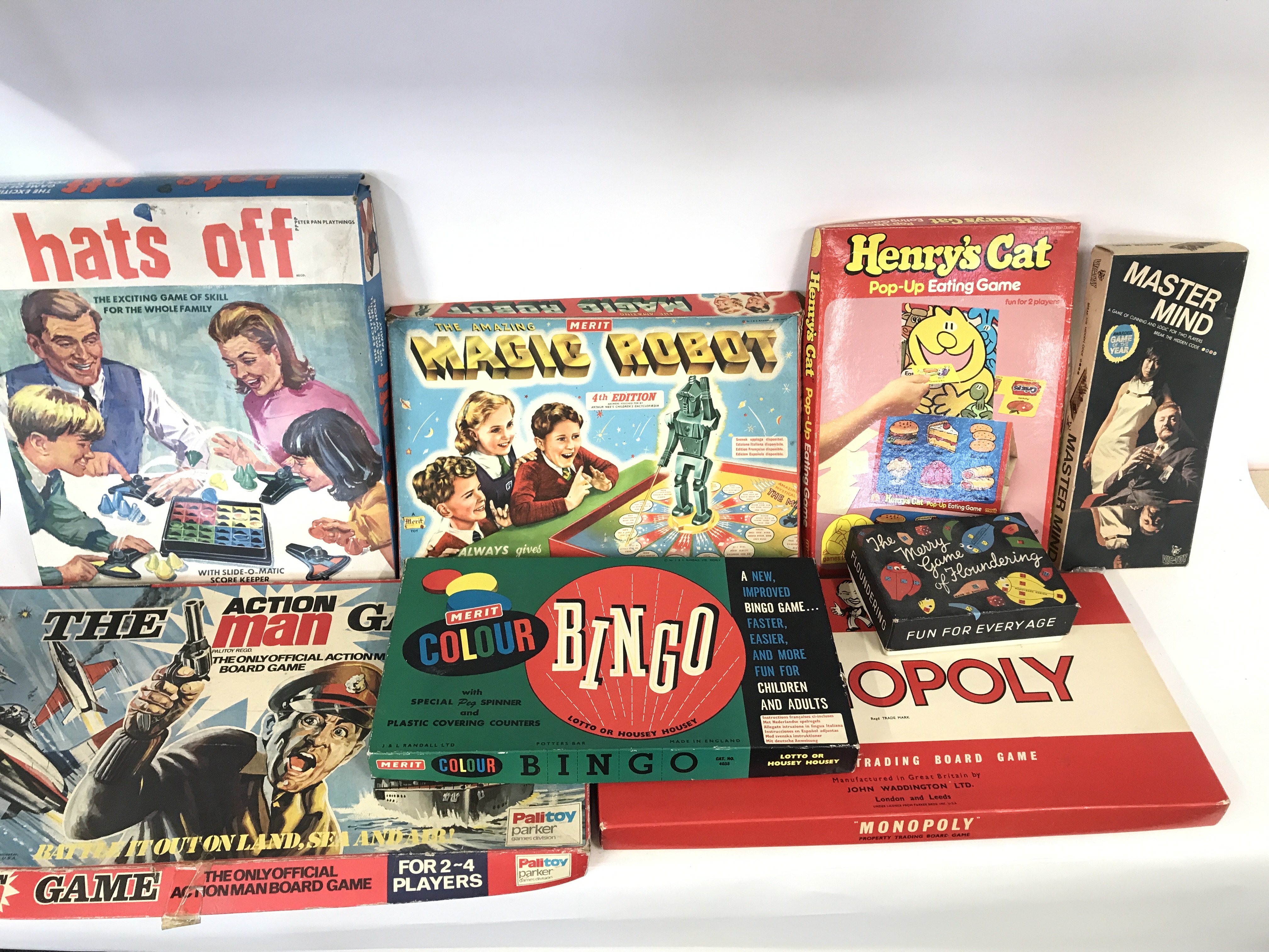 Collection of various board games including magic robot and the action man game.