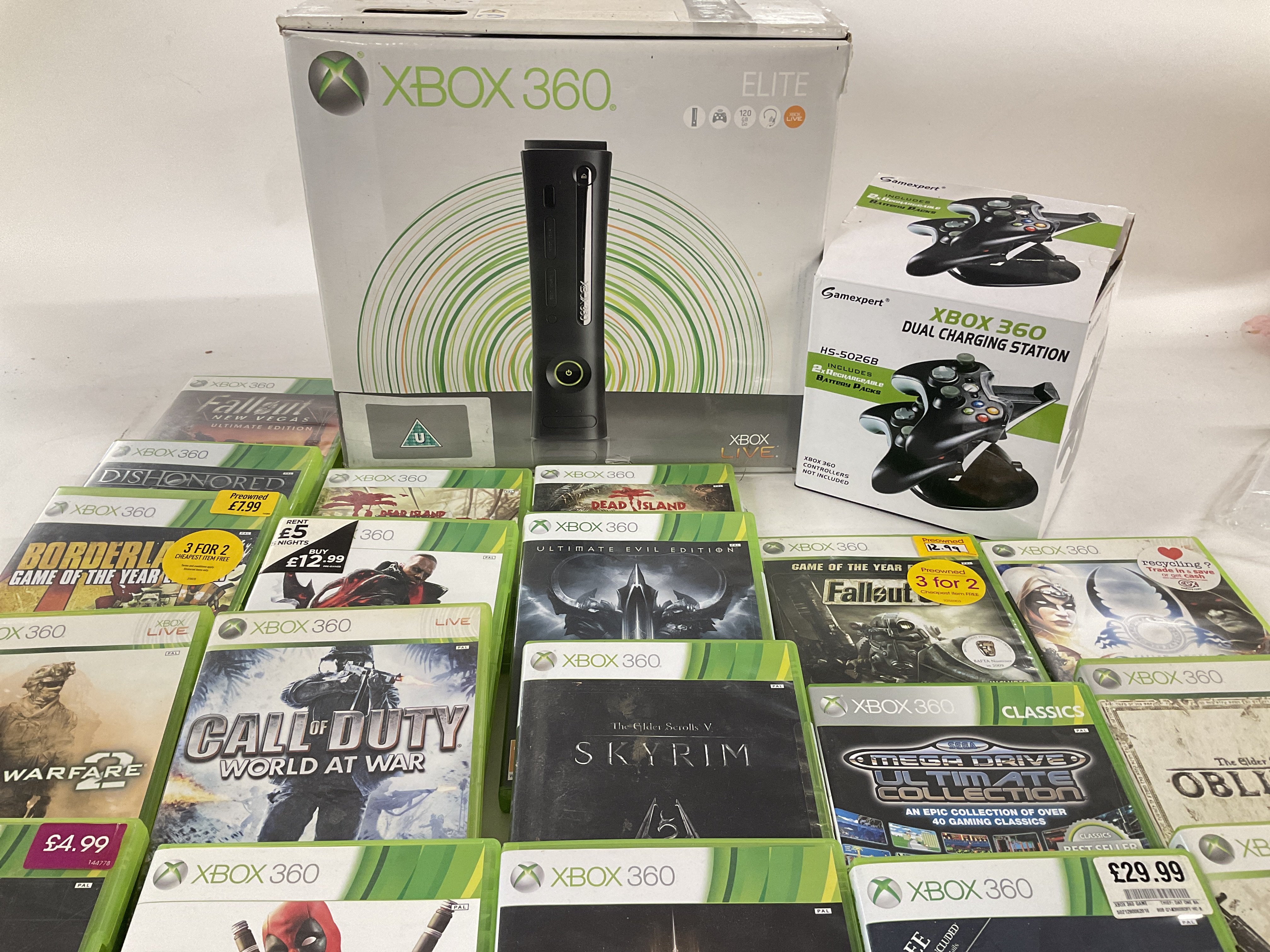 A Box Containing a Boxed XBox 360 with a large amount of Games.