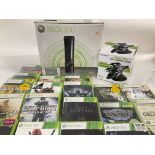 A Box Containing a Boxed XBox 360 with a large amount of Games.
