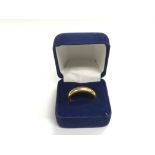 A 22ct gold wedding band, approx 10g and approx si