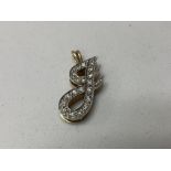 A 14K gold and diamond set J pendant.