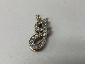 A 14K gold and diamond set J pendant.