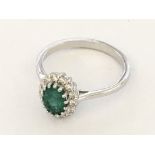 18ct white gold oval emerald and RBC diamonds clus