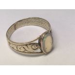 A unmarked gold ring inset with opal with inscript