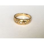 A 3 stone diamond set gypsy ring in yellow gold