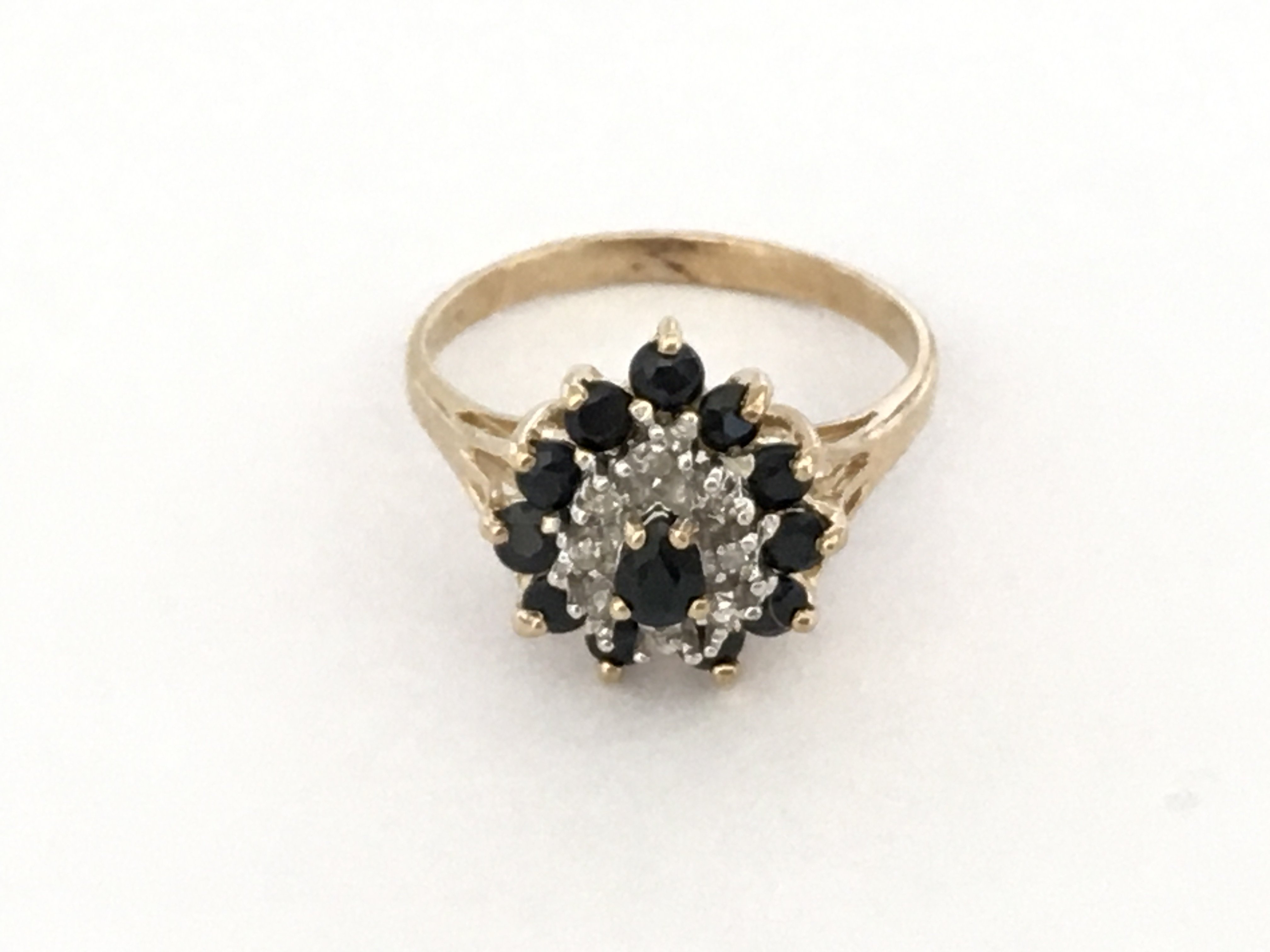 A pear shaped sapphire and diamond cluster ring