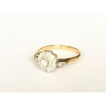 An 18ct gold cluster ring with diamond set shoulde