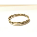 A 9ct gold two tone bangle approximately 14.5g.