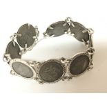 A silver coin bracelet inset with George VI sixpences.