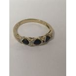 A 9 ct gold ring inset with gem stone and CZ .size P total weight 2 grams