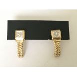 A pair of diamond set earrings in 9ct gold