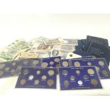 A collection of British bank notes and blue coin a