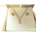 An 18ct gold diamond pendant with matching earring