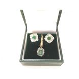 An emerald and diamond earrings and necklace set.